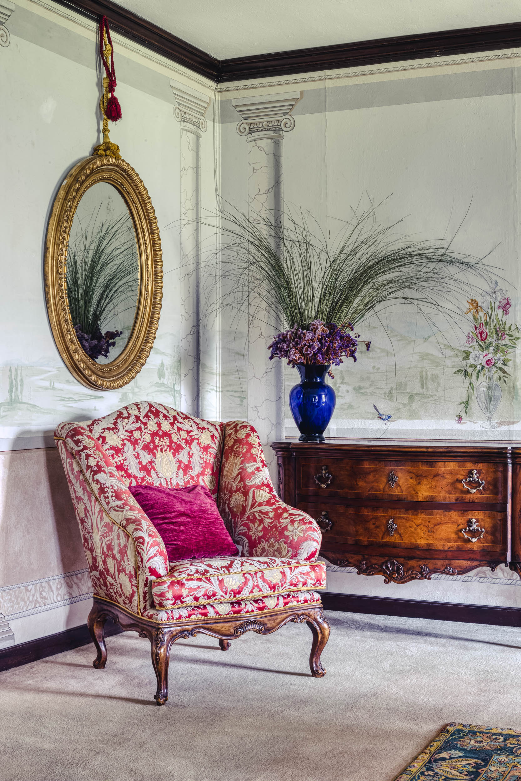 Corner with a vibrant red chair in the Bussandri Villa