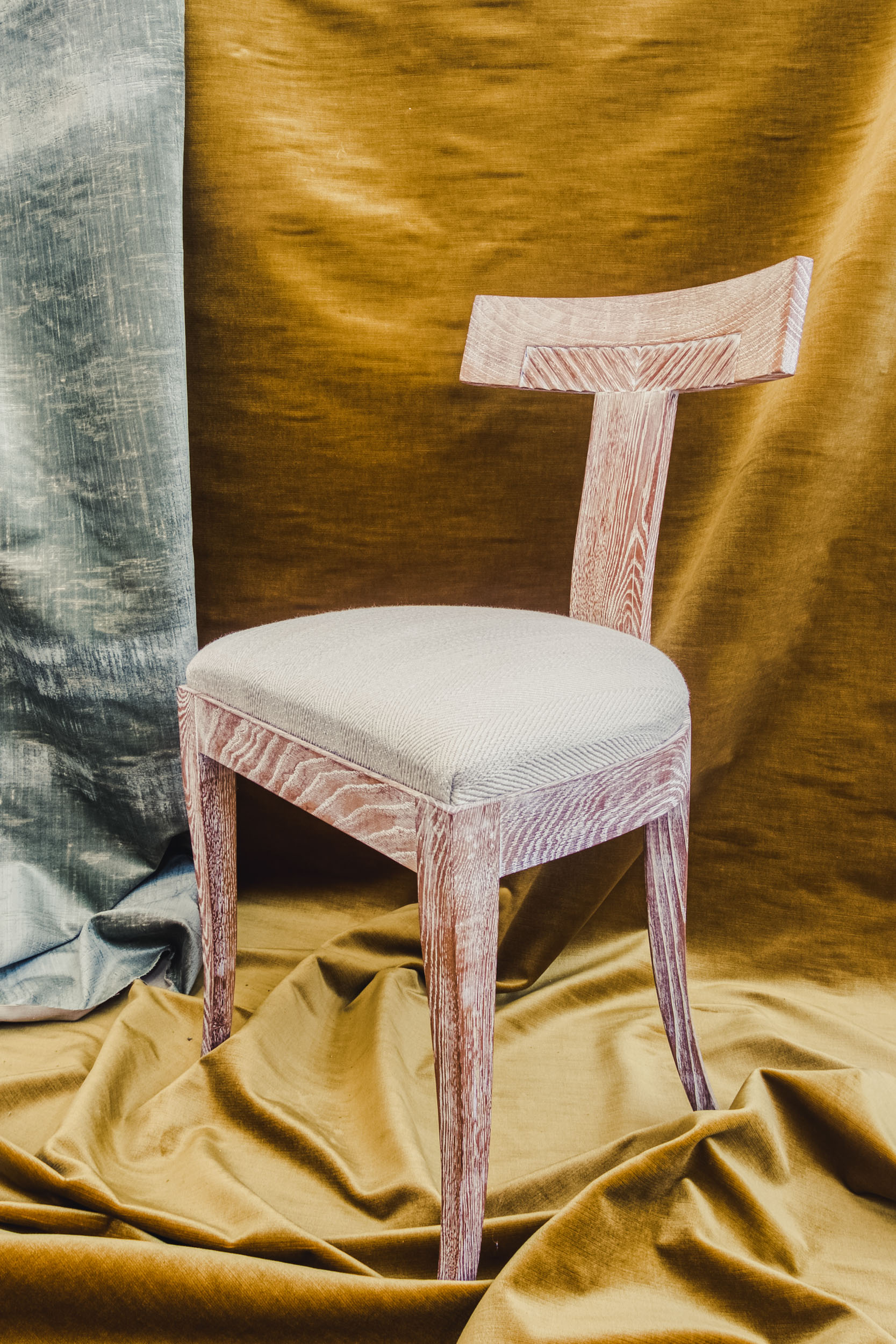 Still life of a chair on a yellow and blue backdrop in the Bussandri Villa