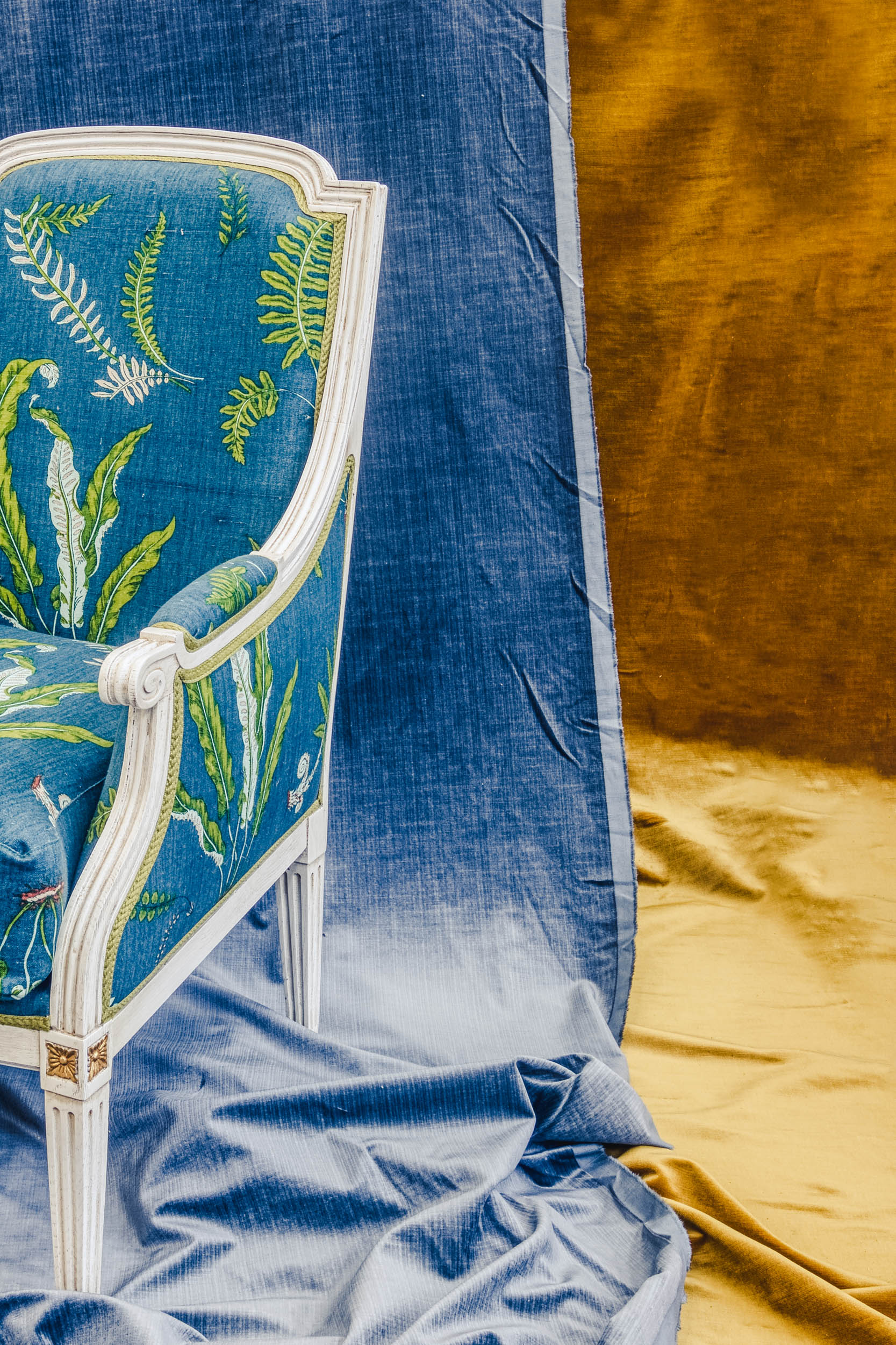 Still life of a blue and green chair on a yellow and blue backdrop in the Bussandri Villa