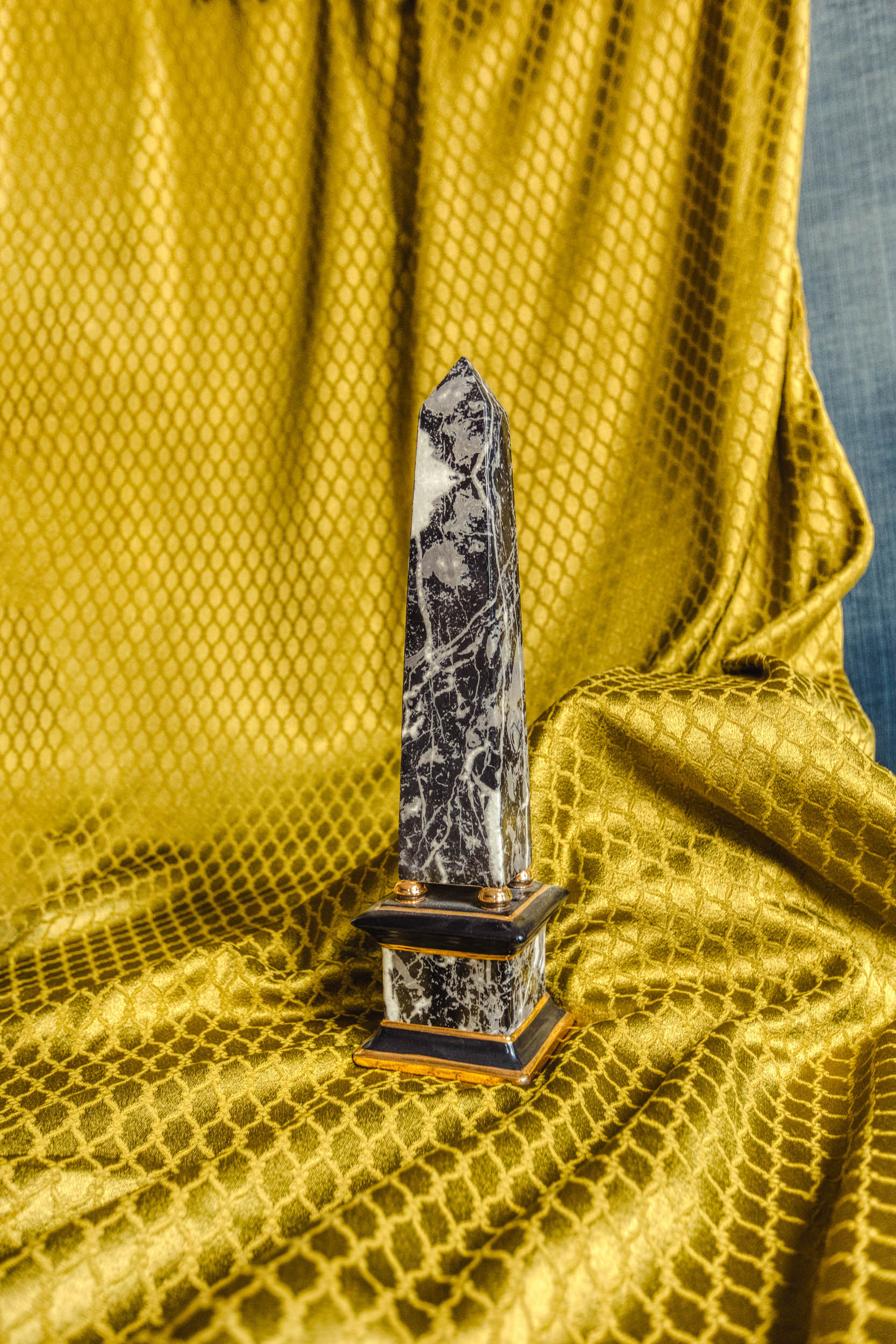 Obelisk on a yellow backdrop in the Bussandri Villa
